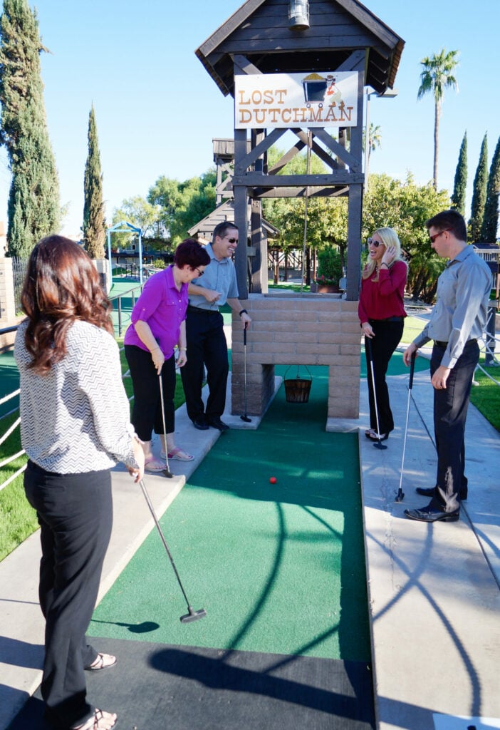 company team playing team builder mini golf