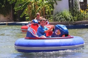 boy riding on a bumper boat