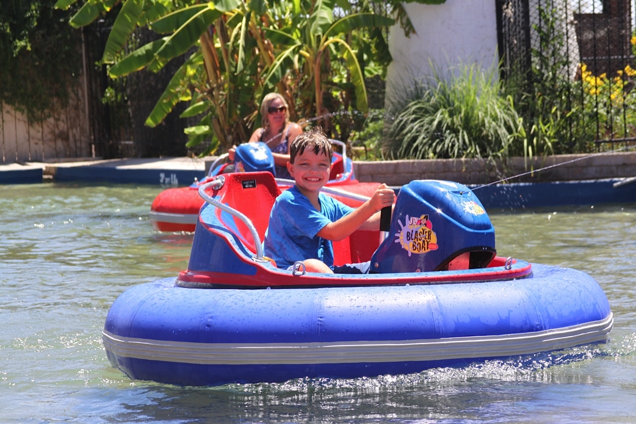 child riding on bumper boats
