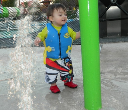 toddler playing at splash pad