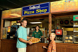 family buying pizza at golfland